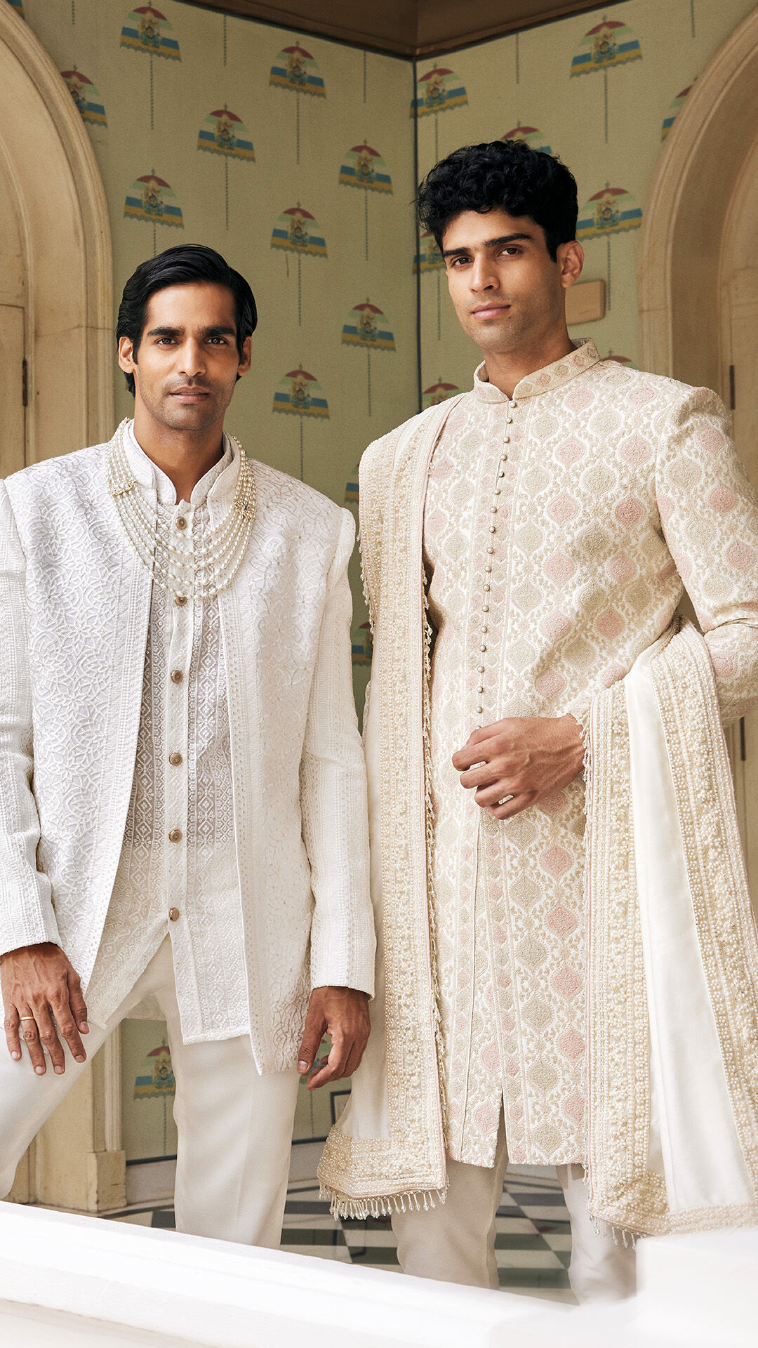 Two men looking stylish in embroidered chikankari kurta sets at a wedding event.